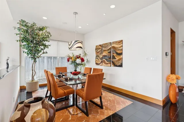 a dining room with furniture and wooden floor