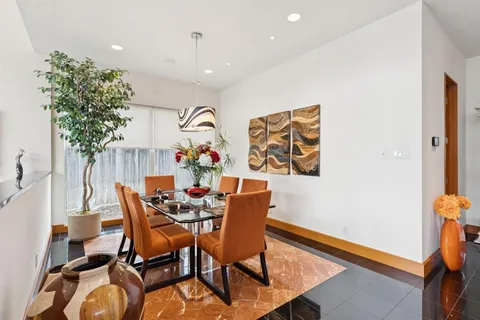 a dining room with furniture and wooden floor