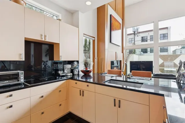 a kitchen with stainless steel appliances a sink a stove and a microwave