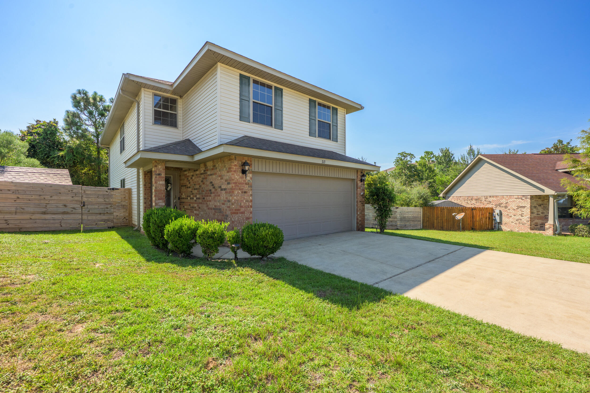 313 Gauntlet Drive Crestview, FL 32539 - Photo 2 of 44 a front view of a house with garden