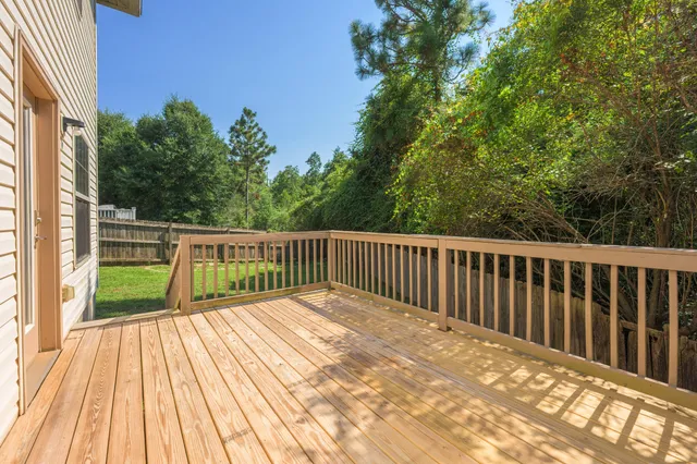 a balcony with view of trees in the background