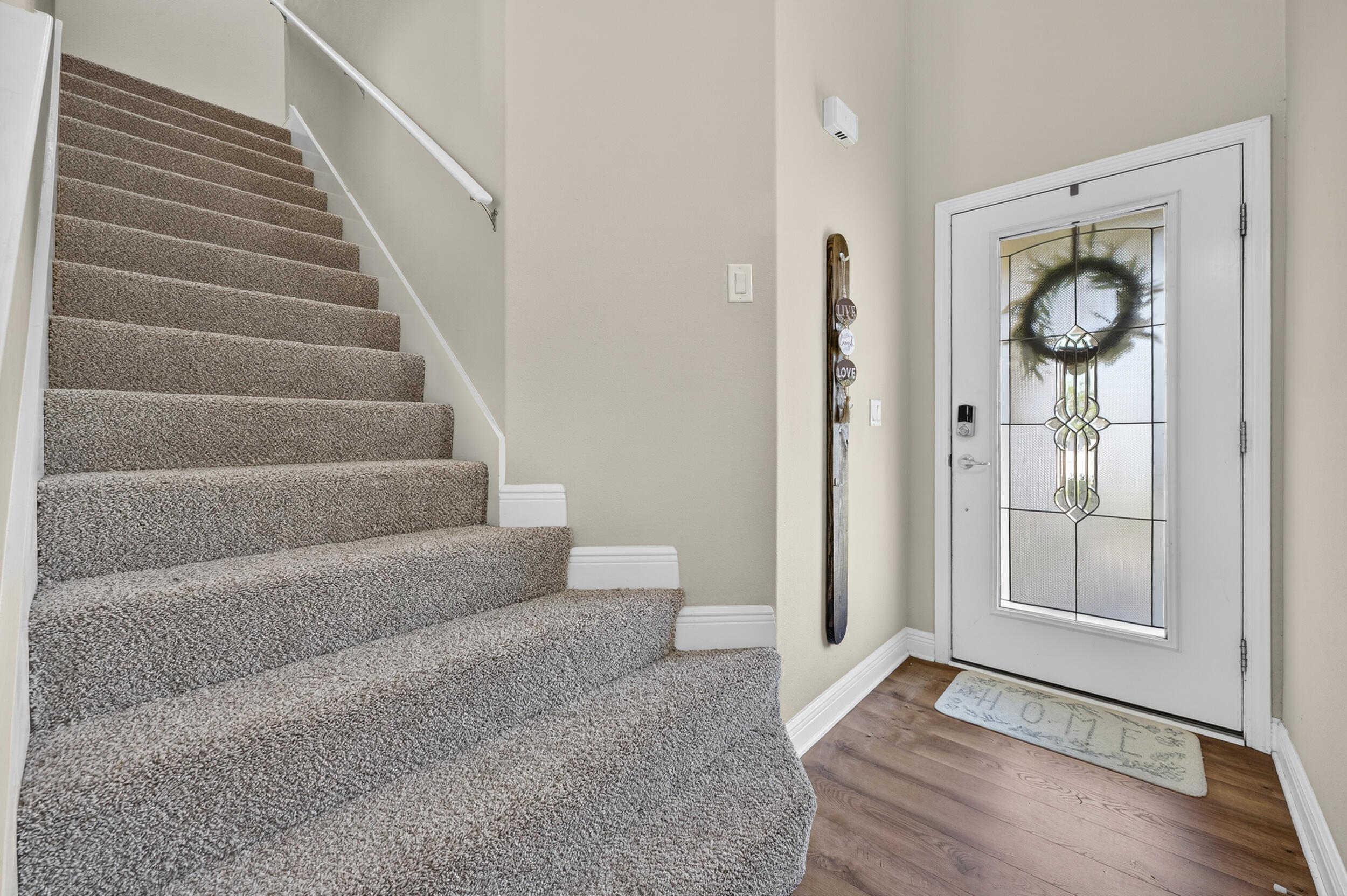 313 Gauntlet Drive Crestview, FL 32539 - Photo 5 of 44 a view of an entryway with wooden floor and mirror
