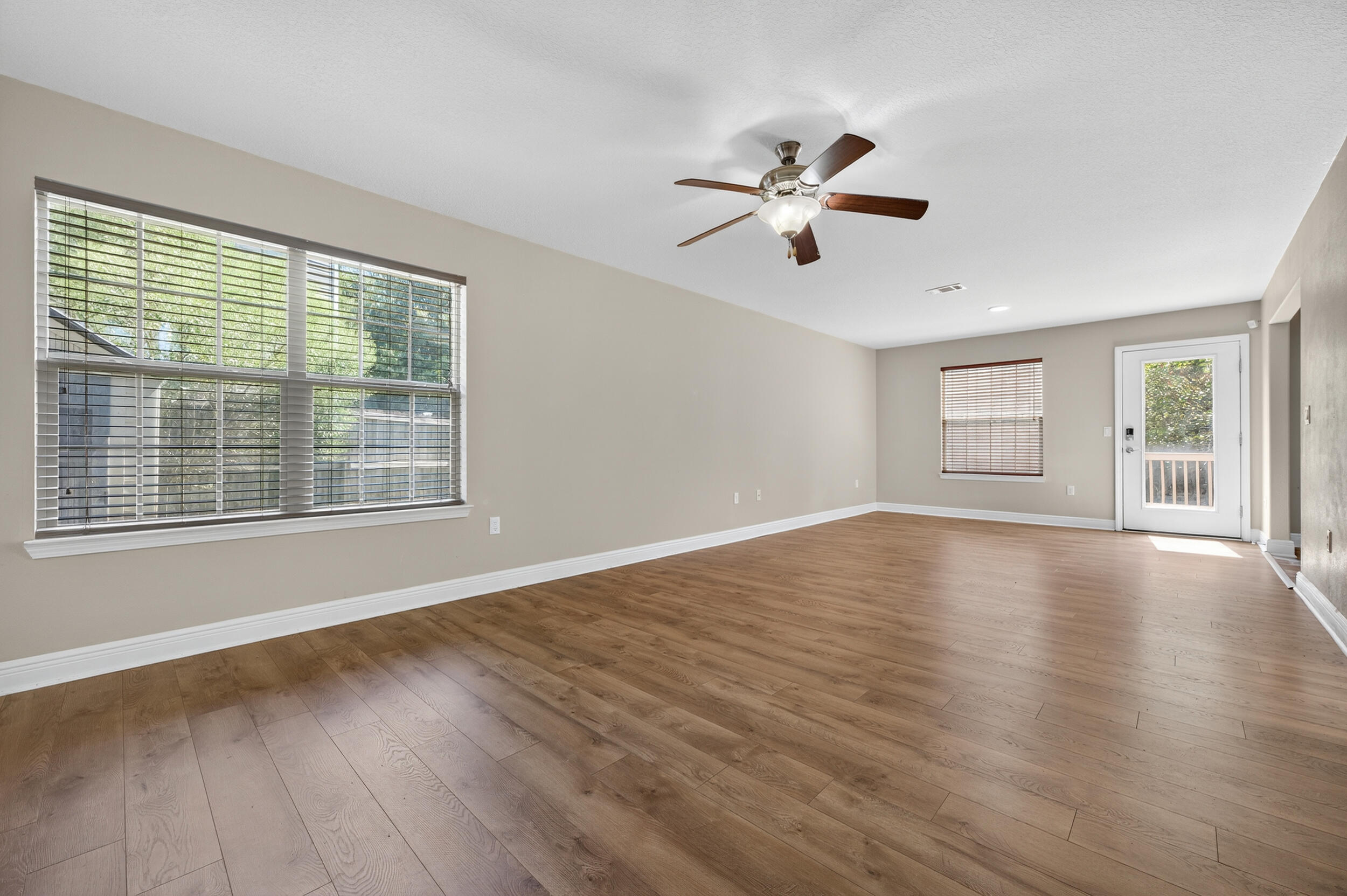 313 Gauntlet Drive Crestview, FL 32539 - Photo 9 of 44 a view of empty room with wooden floor and fan