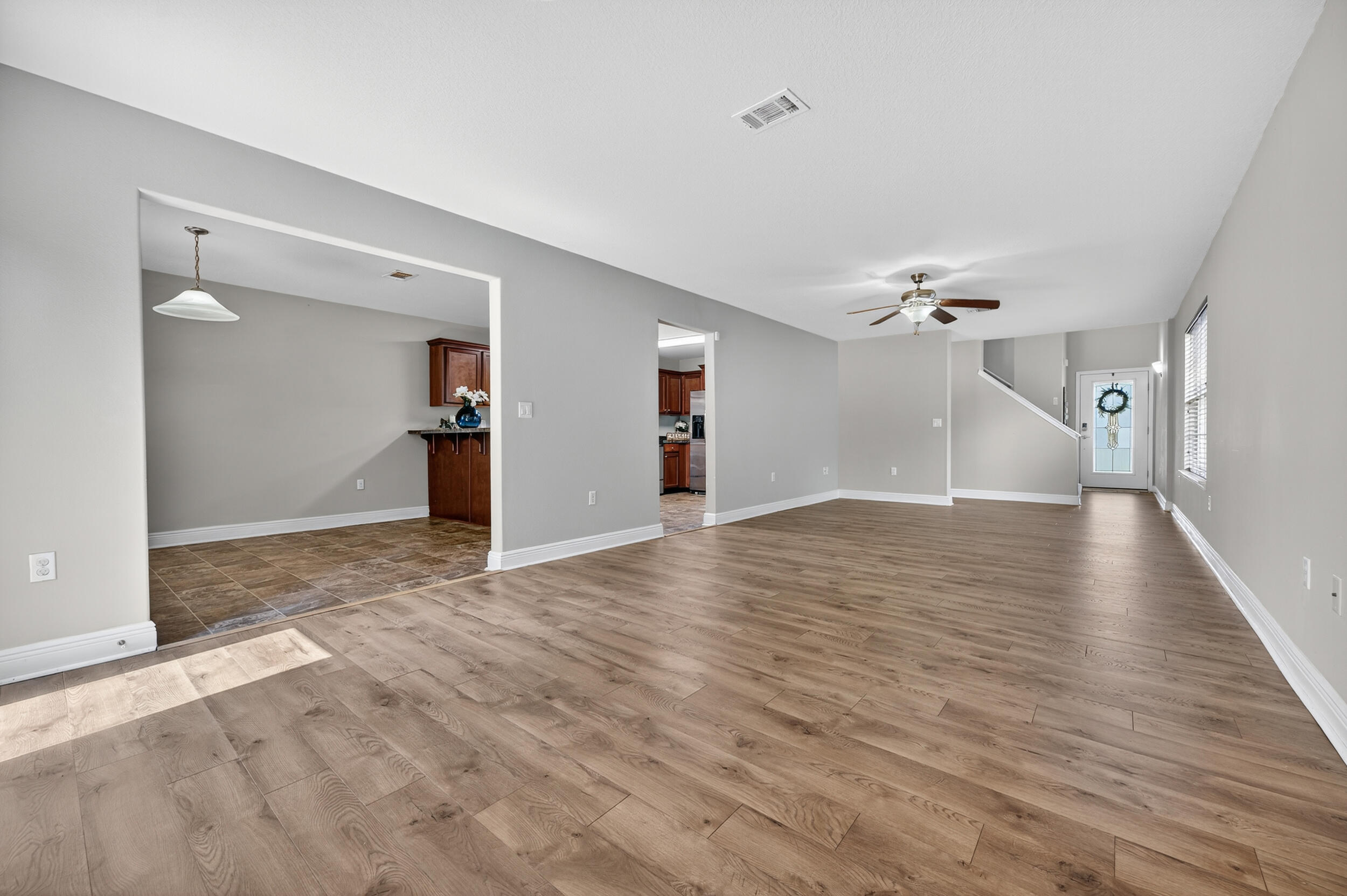 313 Gauntlet Drive Crestview, FL 32539 - Photo 10 of 44 a view of a livingroom with wooden floor and staircase