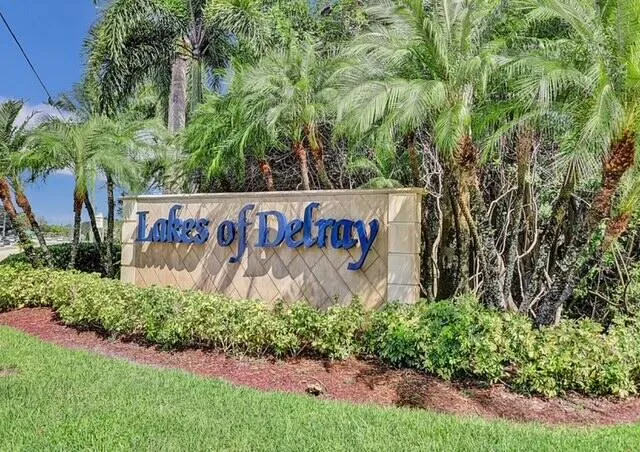 a sign that is in front of flowers