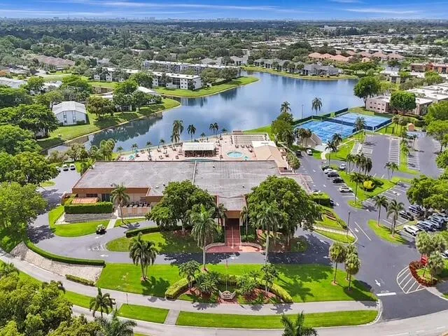 an aerial view of residential houses with outdoor space and lake view