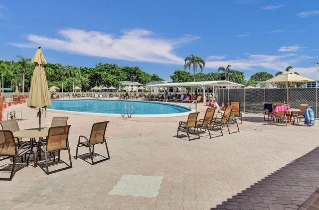 a view of a patio with a table and chairs