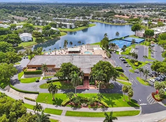 an aerial view of residential houses with outdoor space and swimming pool