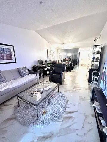 a living room with furniture a rug and a flat screen tv