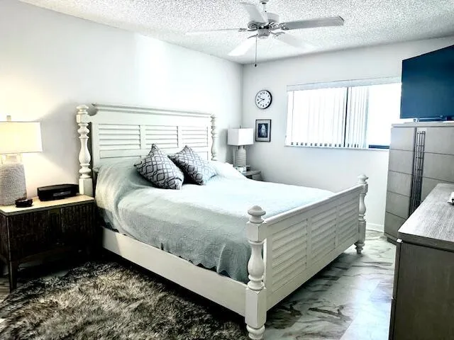 a bedroom with a bed and a television