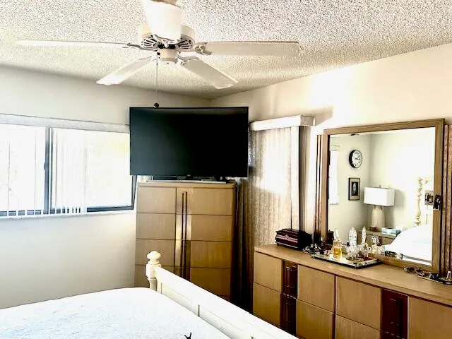 a bathroom with a sink a large mirror and a shower
