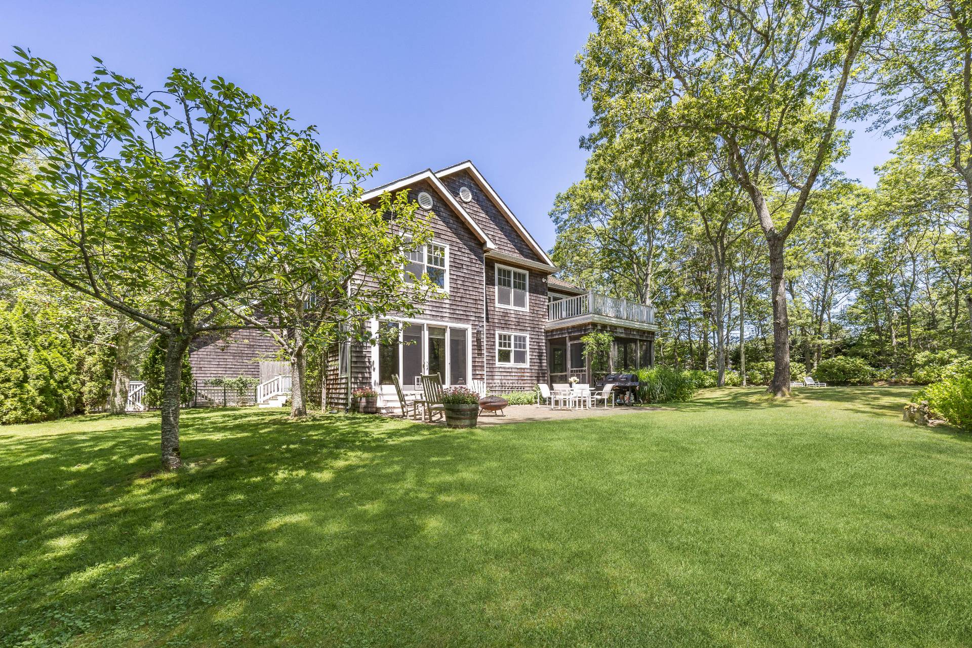 9 Dering Lane East Hampton, NY 11937 - Photo 5 of 30 a view of a house with a big yard and large trees