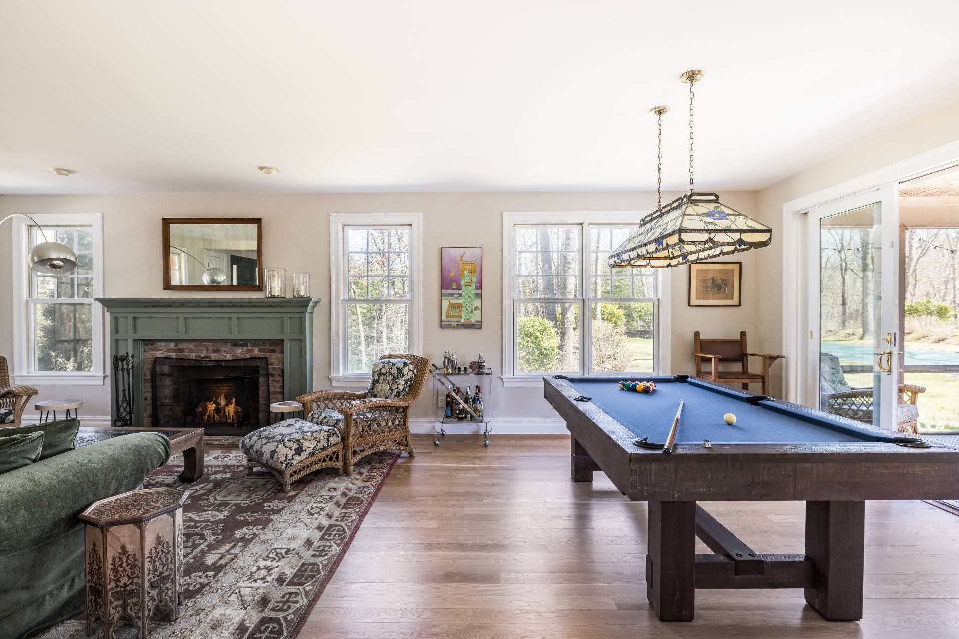 9 Dering Lane East Hampton, NY 11937 - Photo 9 of 30 a living room with furniture a fireplace and a chandelier
