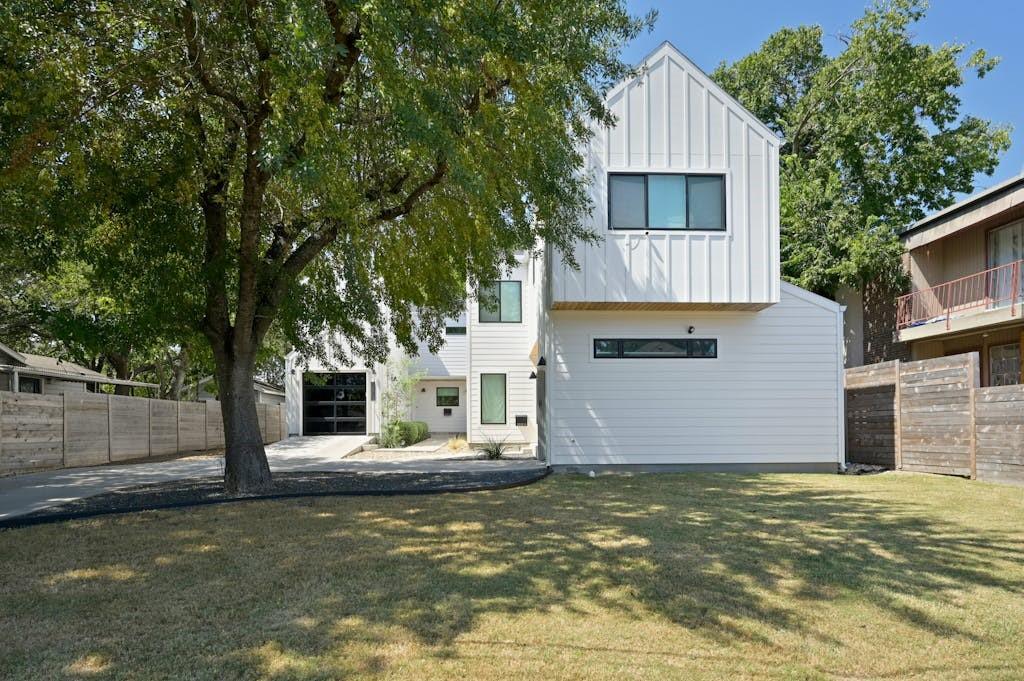 5212 Huisache Street, Unit 2 Austin, TX 78751 - Photo 2 of 30 Rear view of property with board and batten siding and driveway