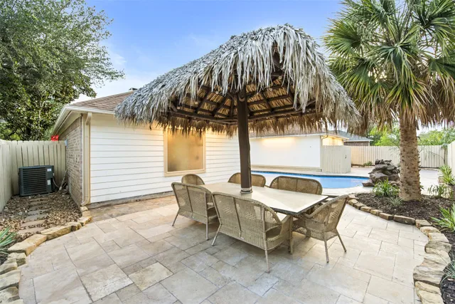 a backyard of a house with table and chairs