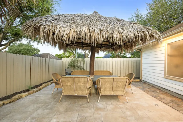 a patio with a table and chairs
