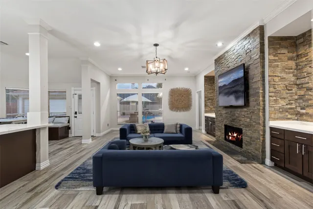 a living room with furniture a fireplace and a flat screen tv