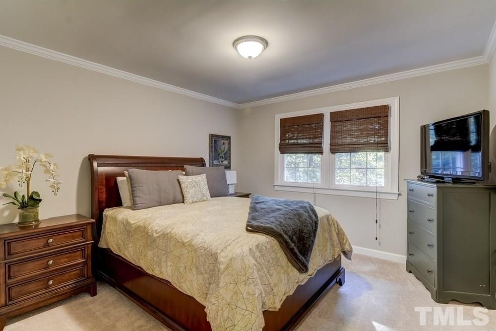 3005 Old Orchard Road Raleigh, NC 27607 - Photo 13 of 21 a bed sitting in a bedroom next to a window