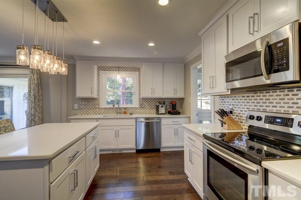 3005 Old Orchard Road Raleigh, NC 27607 - Photo 8 of 21 a kitchen with a sink stove and microwave