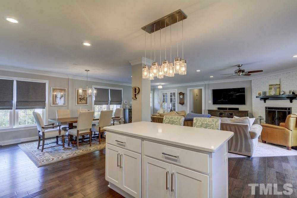 3005 Old Orchard Road Raleigh, NC 27607 - Photo 10 of 21 a view of a dining room with furniture a chandelier and wooden floor