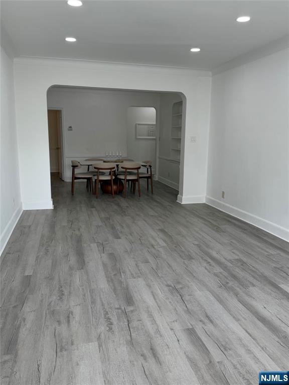 100 Prospect Avenue, Unit 2E Hackensack, NJ 07601 - Photo 7 of 16 a view of a room with wooden floor and furniture
