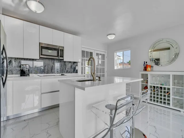 a kitchen with cabinets and window