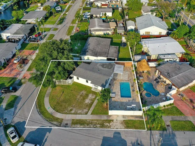 an aerial view of residential houses with outdoor space
