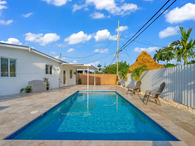 a view of a backyard with swimming pool
