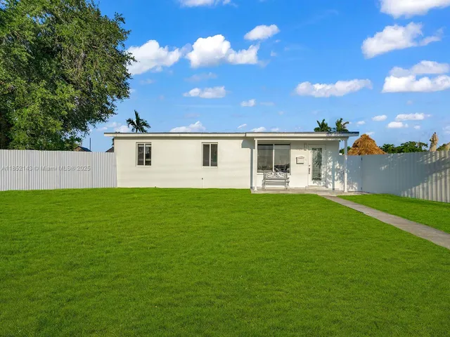 a view of a house with a backyard