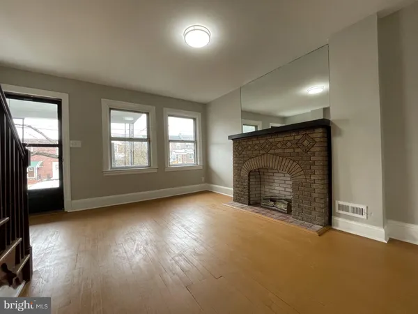 an empty room with a fireplace and window