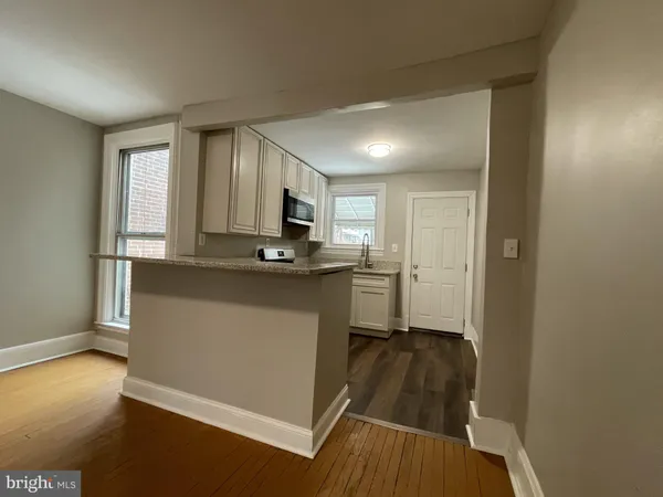a kitchen with kitchen island a counter top space a sink and appliances