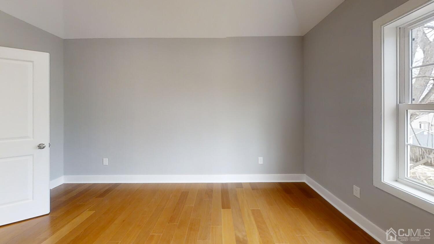 26 Highfield Road Colonia, NJ 07067 - Photo 17 of 30 a view of an empty room with wooden floor and a window