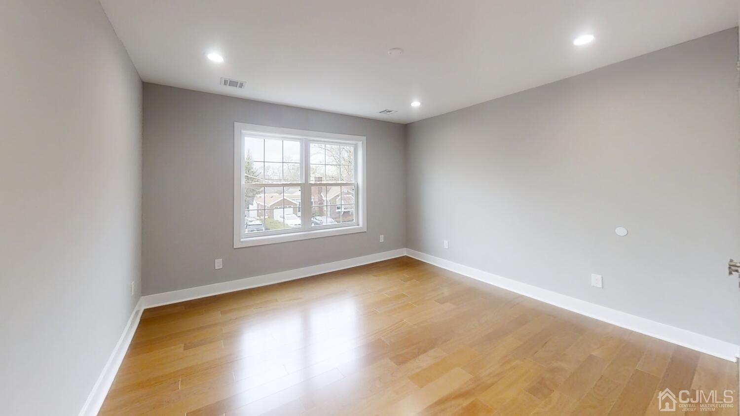 26 Highfield Road Colonia, NJ 07067 - Photo 19 of 30 an empty room with wooden floor and windows