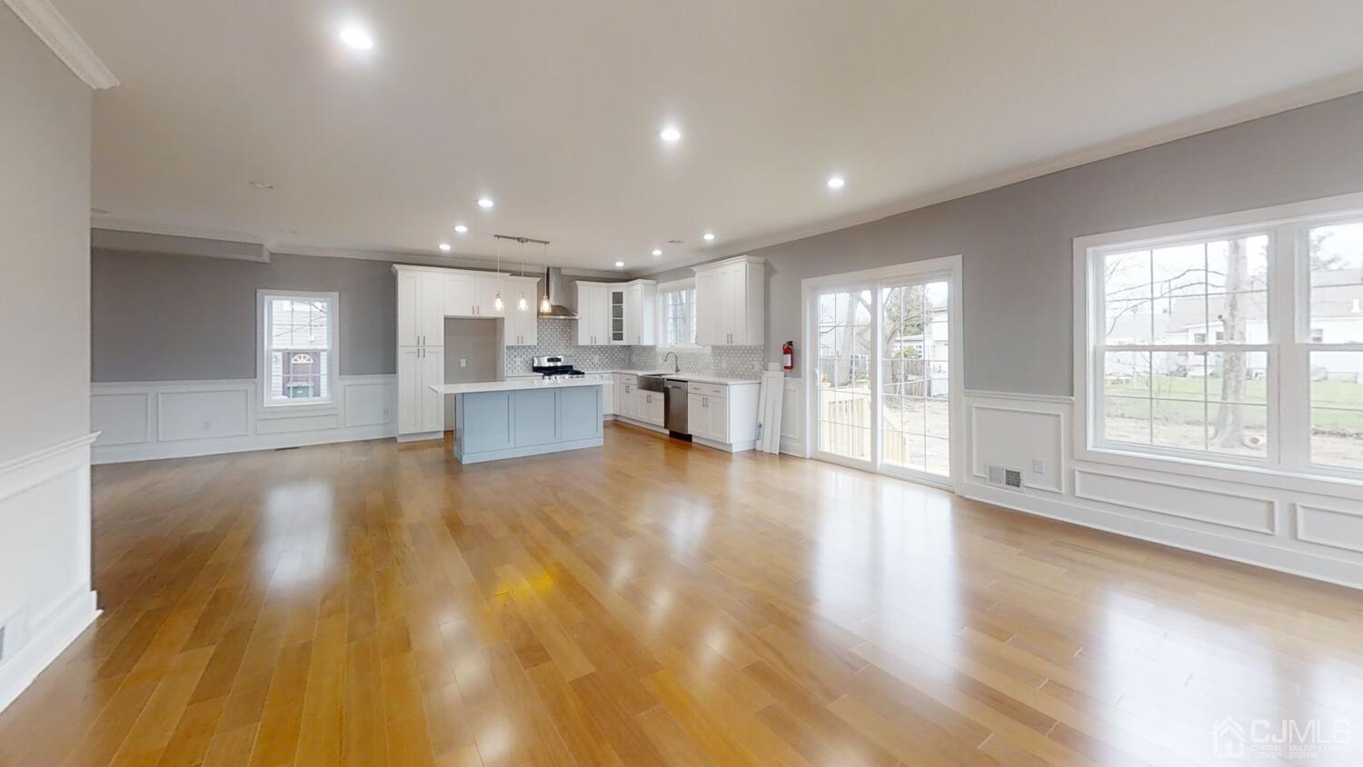 26 Highfield Road Colonia, NJ 07067 - Photo 9 of 30 a view of an empty room and kitchen with wooden floor
