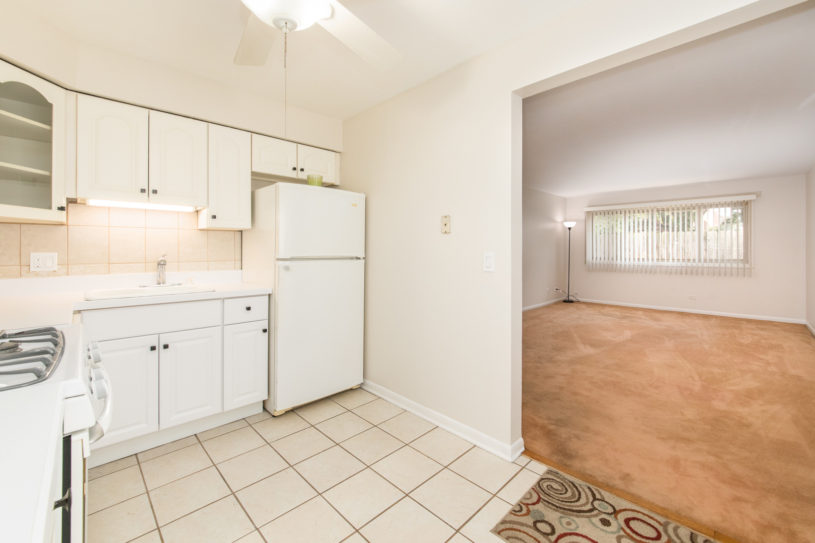 1363 Perry Street, Unit 1B Des Plaines, IL 60016 - Photo 6 of 12 a kitchen with white cabinets and white appliances