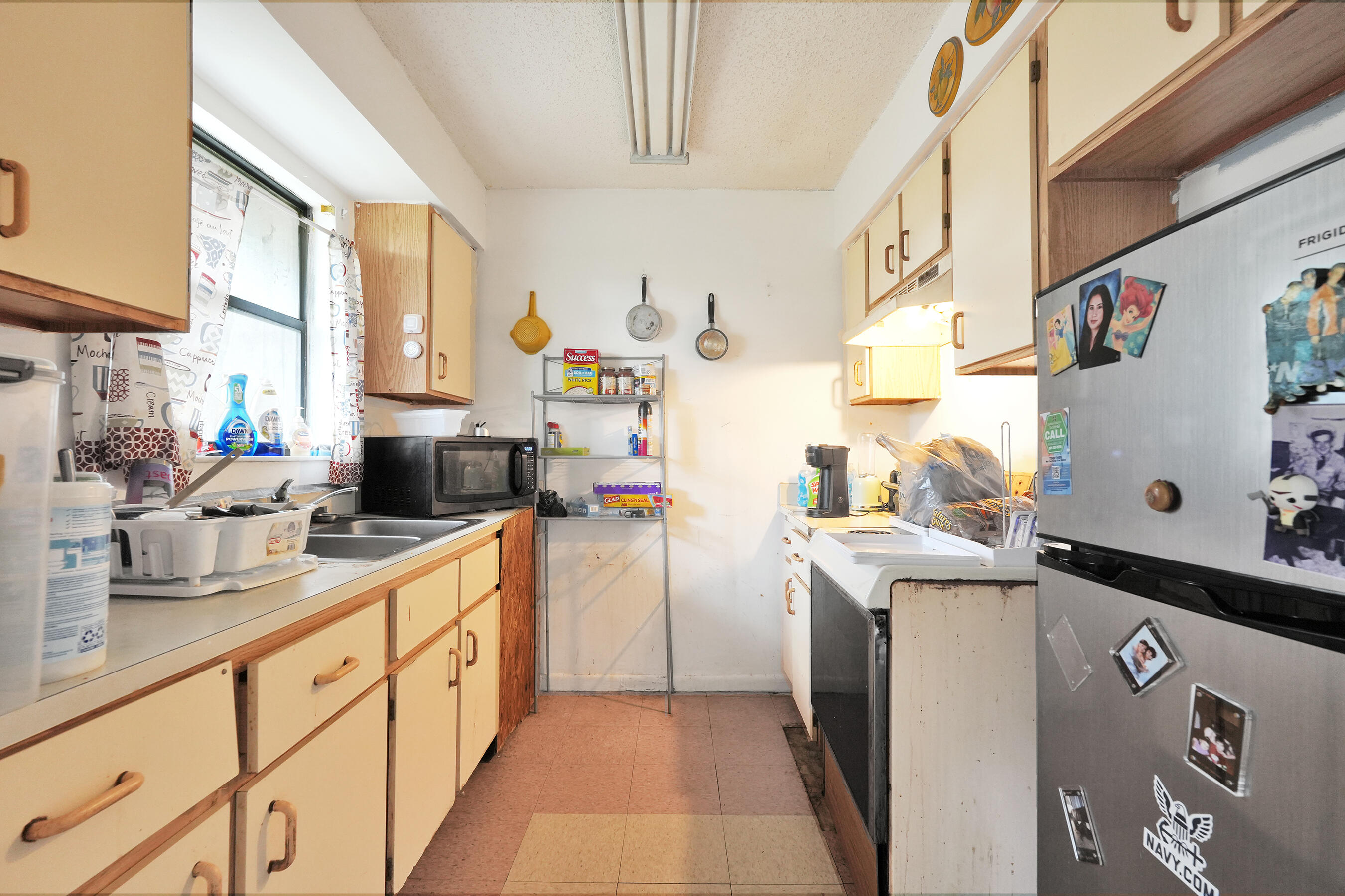 6505 Dockside Circle Greenacres, FL 33463 - Photo 11 of 38 a kitchen with a sink a refrigerator and washer