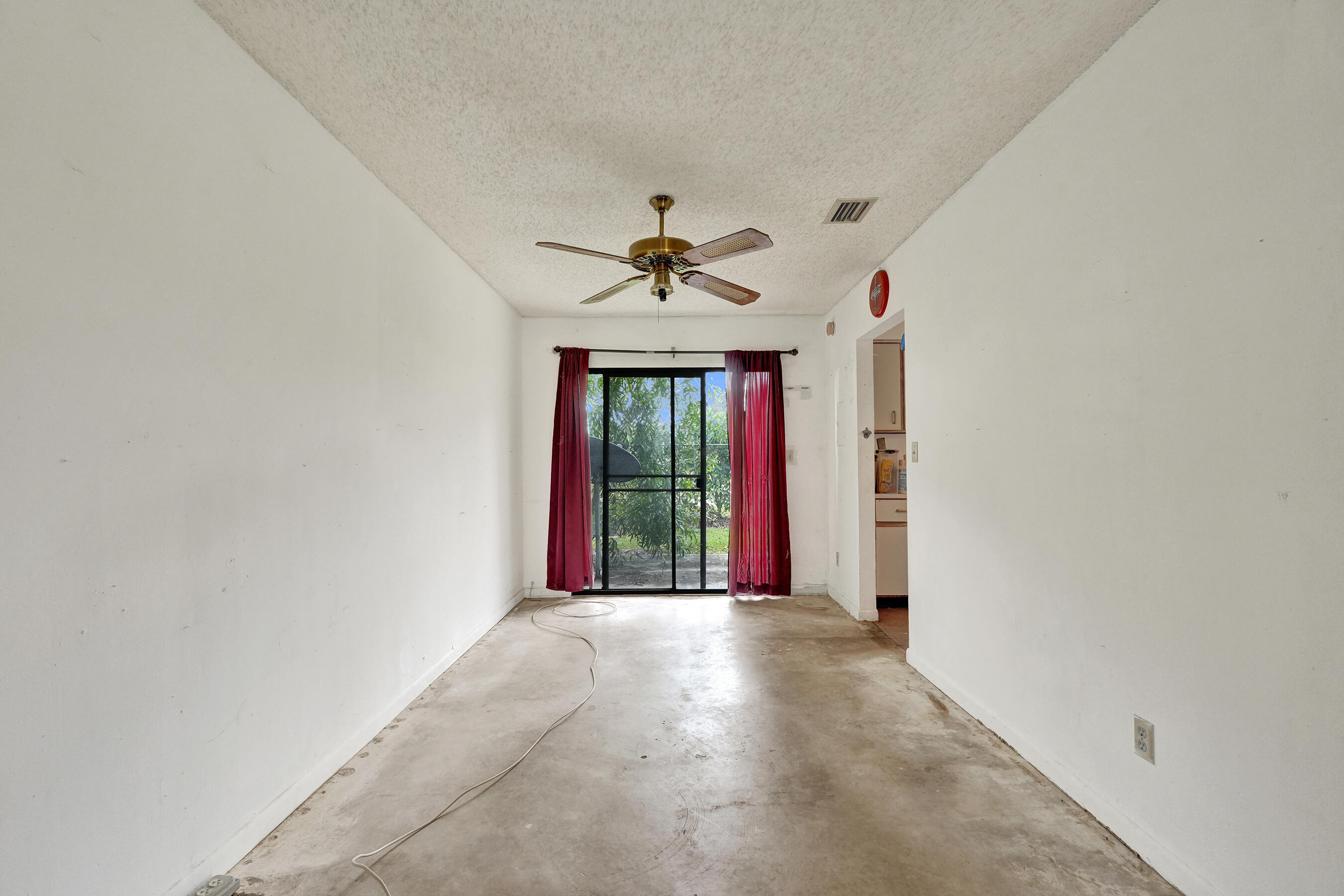 6505 Dockside Circle Greenacres, FL 33463 - Photo 13 of 38 a view of a livingroom with a ceiling fan and window