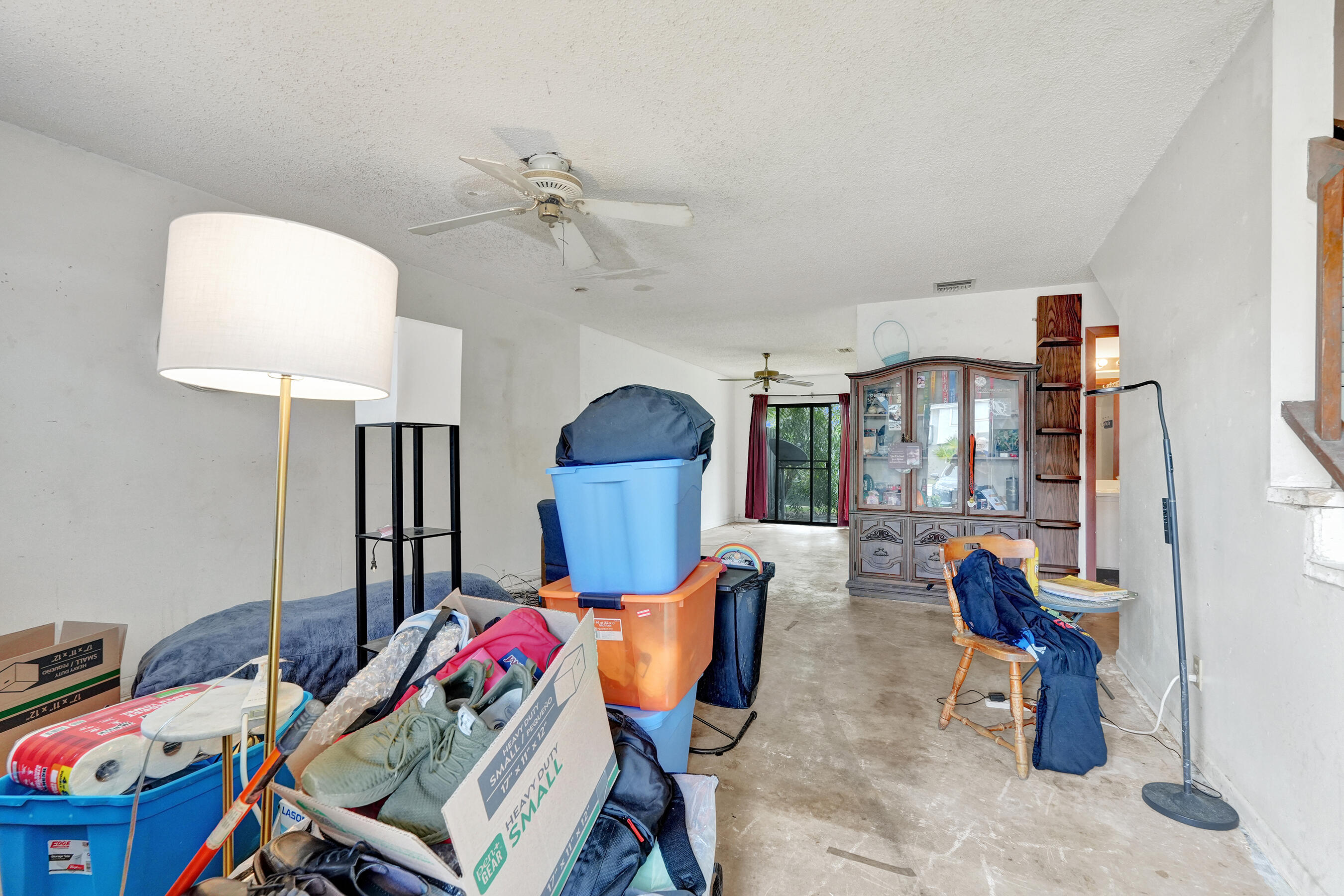 6505 Dockside Circle Greenacres, FL 33463 - Photo 19 of 38 a living room with furniture a rug and a chandelier