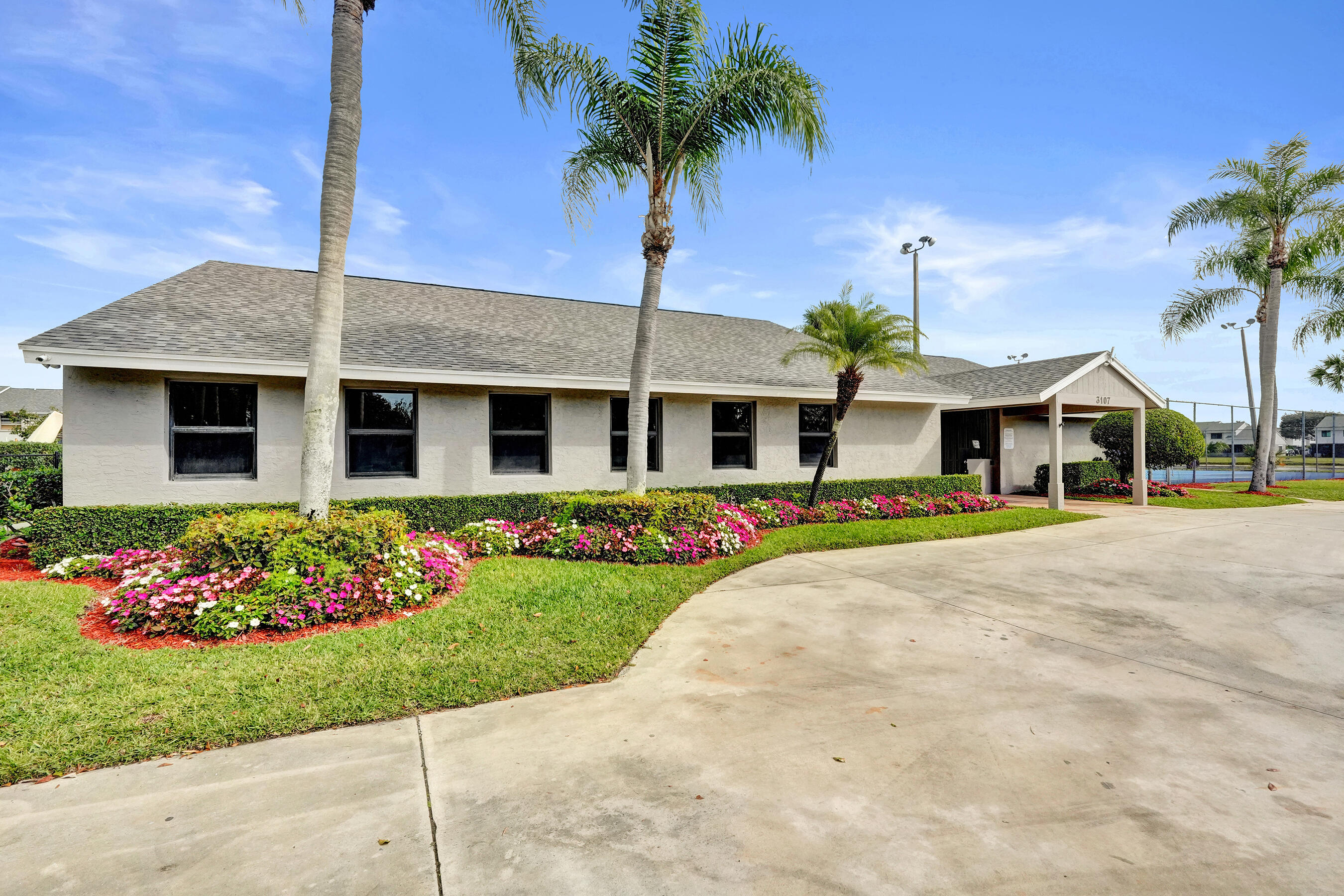 6505 Dockside Circle Greenacres, FL 33463 - Photo 24 of 38 a front view of house with yard and green space