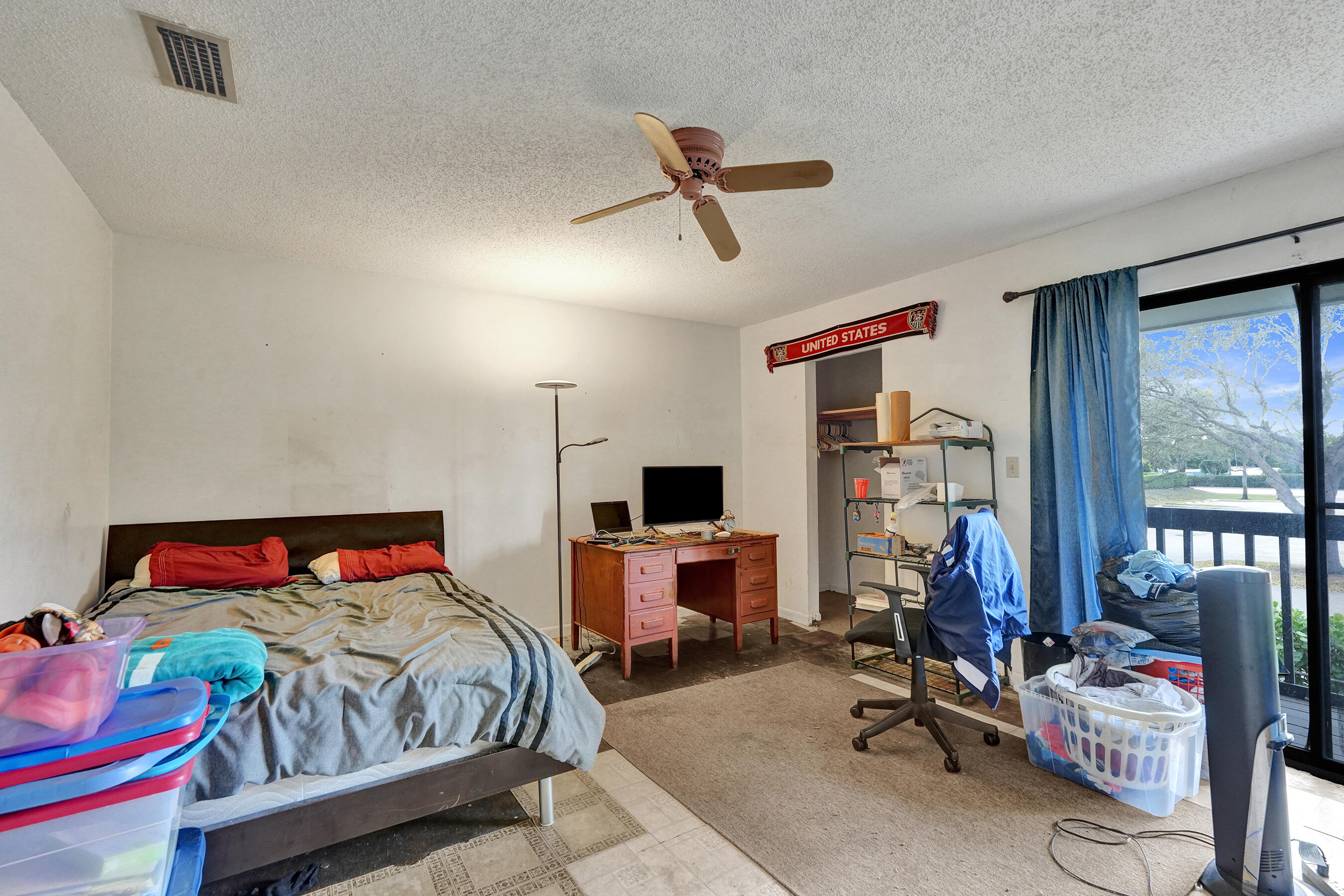 6505 Dockside Circle Greenacres, FL 33463 - Photo 30 of 38 a bedroom with a bed a couch and a window