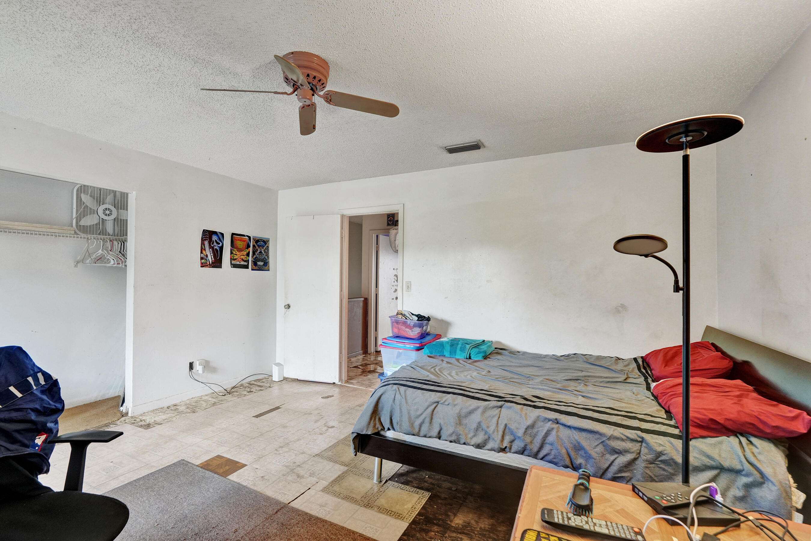 6505 Dockside Circle Greenacres, FL 33463 - Photo 32 of 38 a bedroom with a bed and a chandelier fan