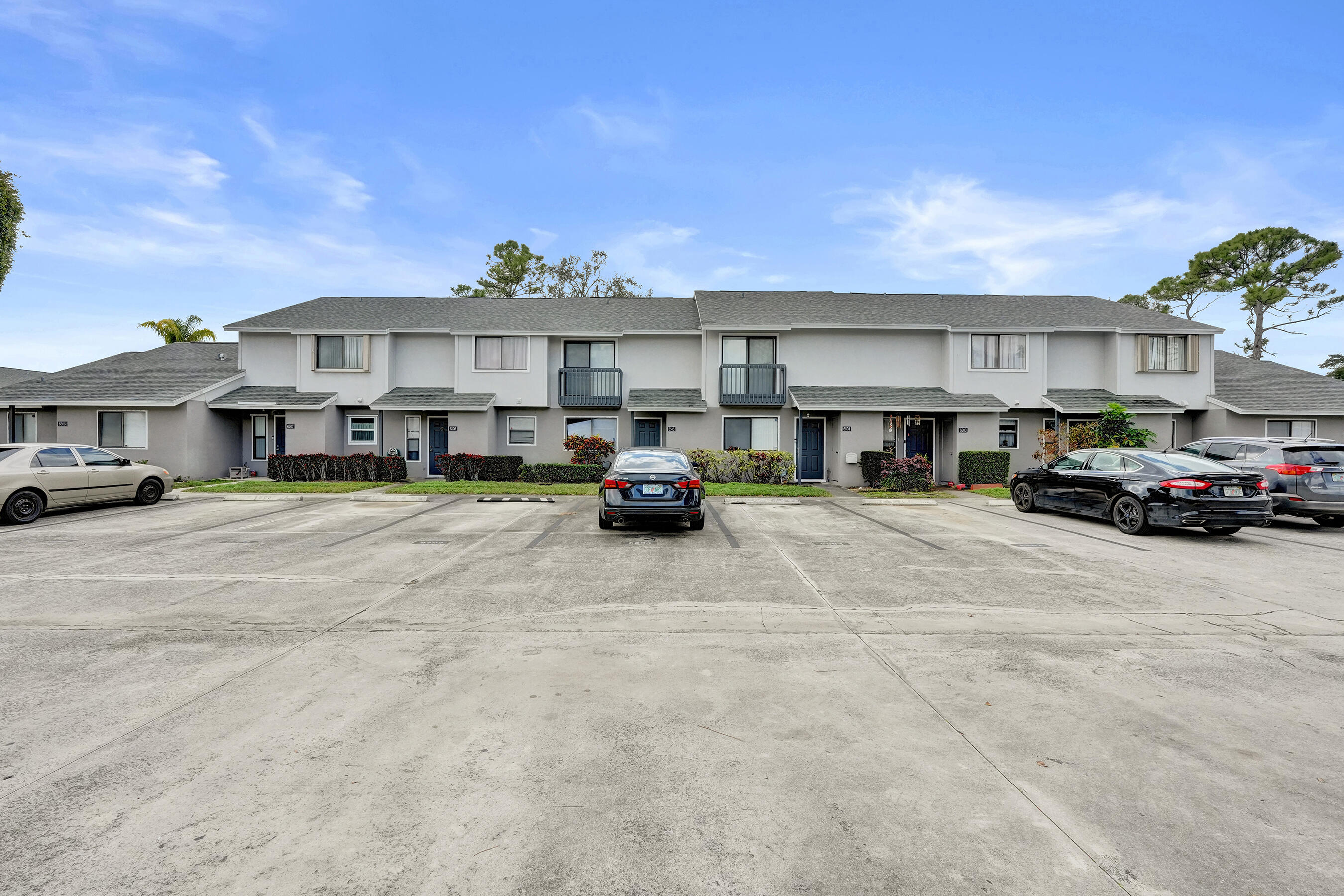 6505 Dockside Circle Greenacres, FL 33463 - Photo 9 of 38 a car parked in front of a building