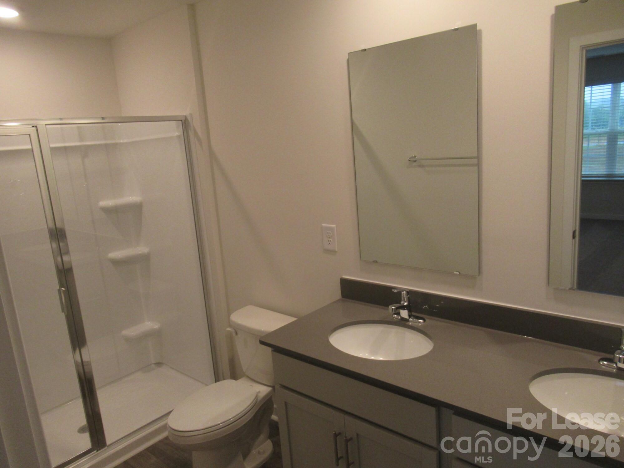 3192 Ora Smith Road Lincolnton, NC 28092 - Photo 15 of 34 a bathroom with a granite countertop sink toilet and shower