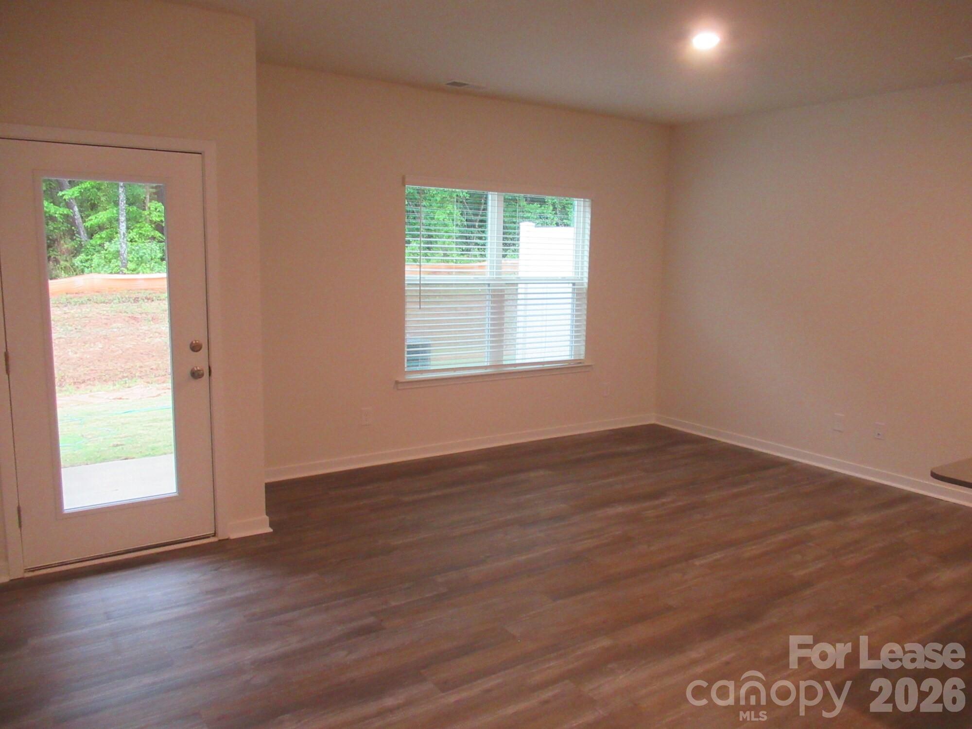 3192 Ora Smith Road Lincolnton, NC 28092 - Photo 5 of 34 an empty room with wooden floor and windows