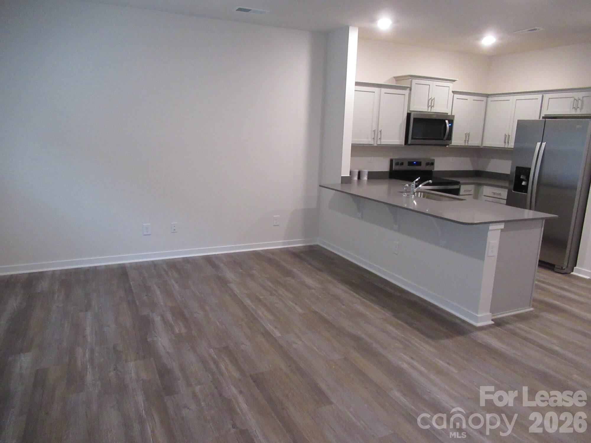 3192 Ora Smith Road Lincolnton, NC 28092 - Photo 6 of 34 a view of kitchen with stainless steel appliances wooden floor and counter top space