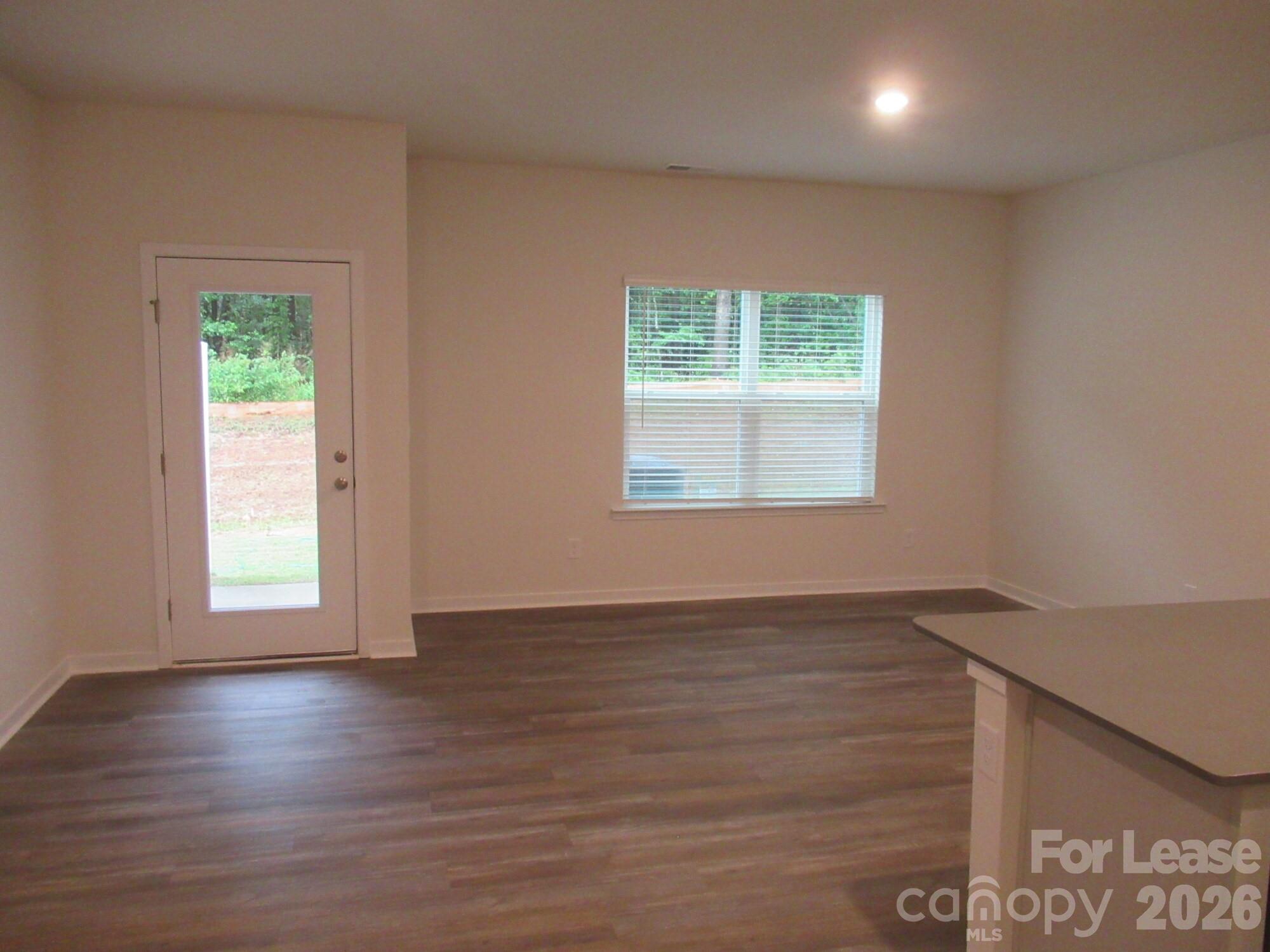 3192 Ora Smith Road Lincolnton, NC 28092 - Photo 7 of 34 an empty room with wooden floor and windows