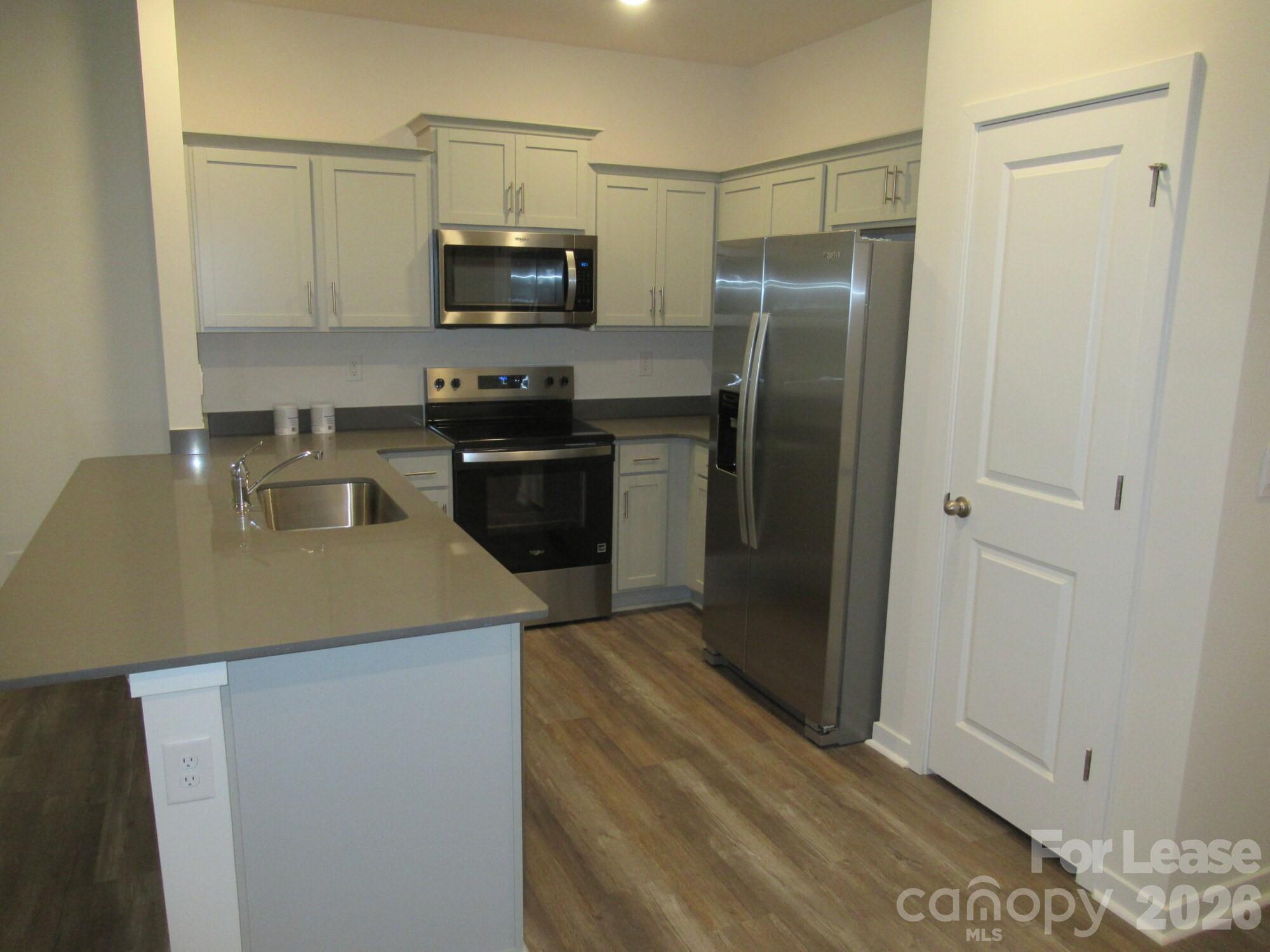 3192 Ora Smith Road Lincolnton, NC 28092 - Photo 10 of 34 a kitchen with a sink a refrigerator and cabinets