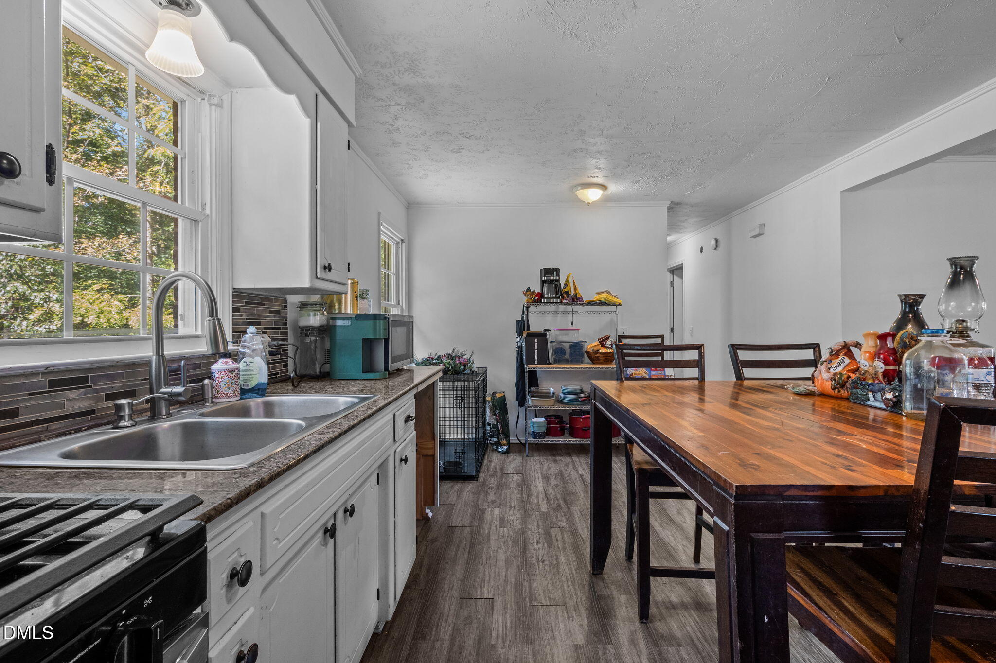 670 Tingen Mine Road Roxboro, NC 27574 - Photo 10 of 30 a kitchen with granite countertop a sink stove and cabinets