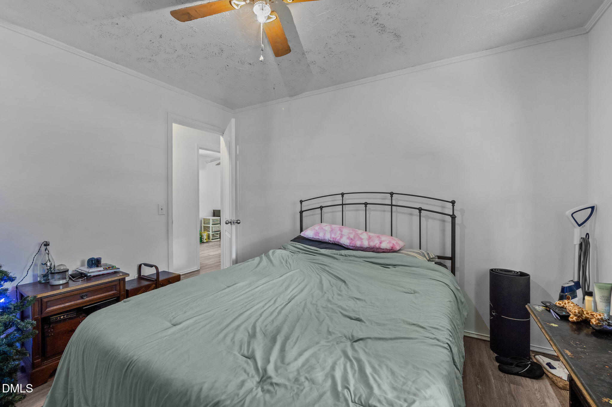 670 Tingen Mine Road Roxboro, NC 27574 - Photo 12 of 30 a bedroom with a bed and a chandelier
