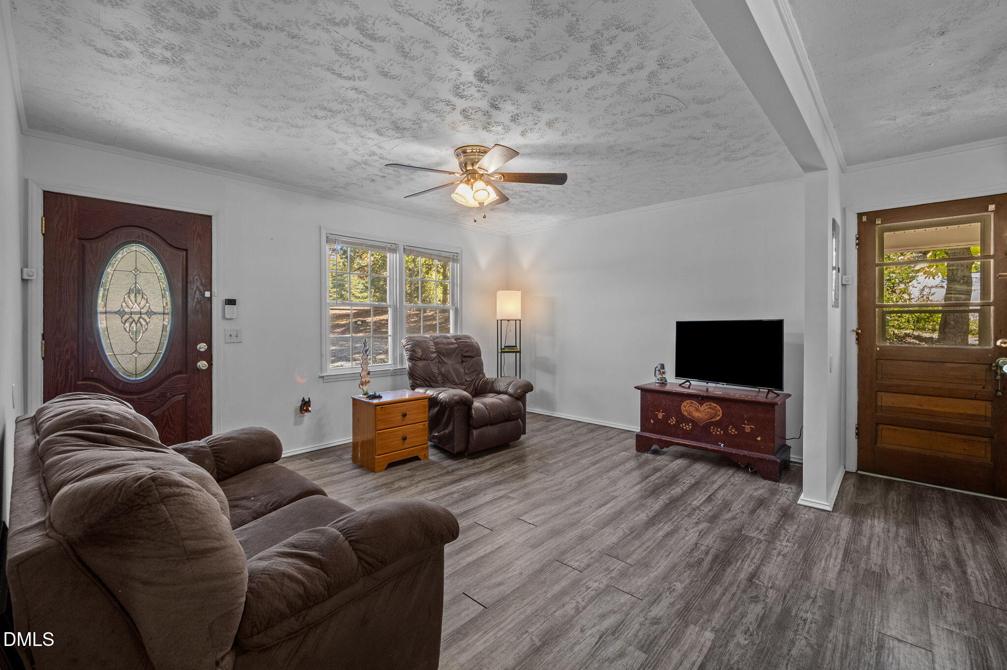 670 Tingen Mine Road Roxboro, NC 27574 - Photo 3 of 30 a living room with furniture a wooden floor and a large window